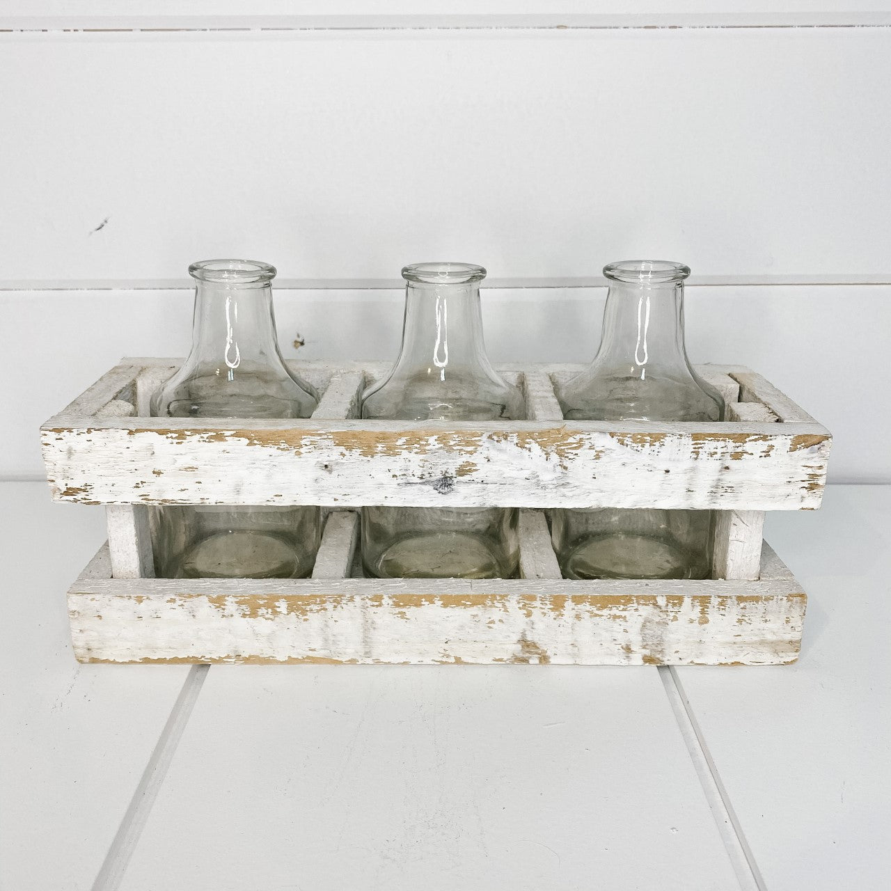 Whitewashed wooden bud vase crate.